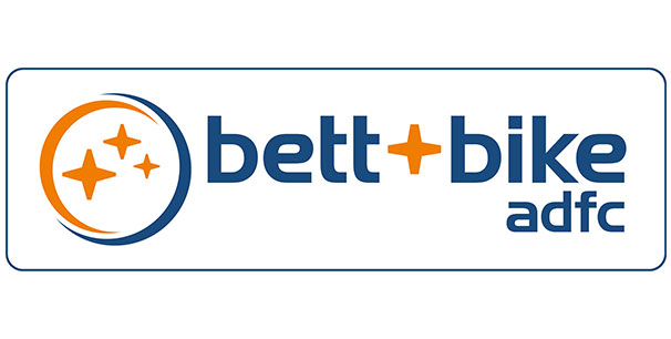 Logo von "bett+bike adfc" mit blauem und orangefarbenem Text und Sternsymbolen.